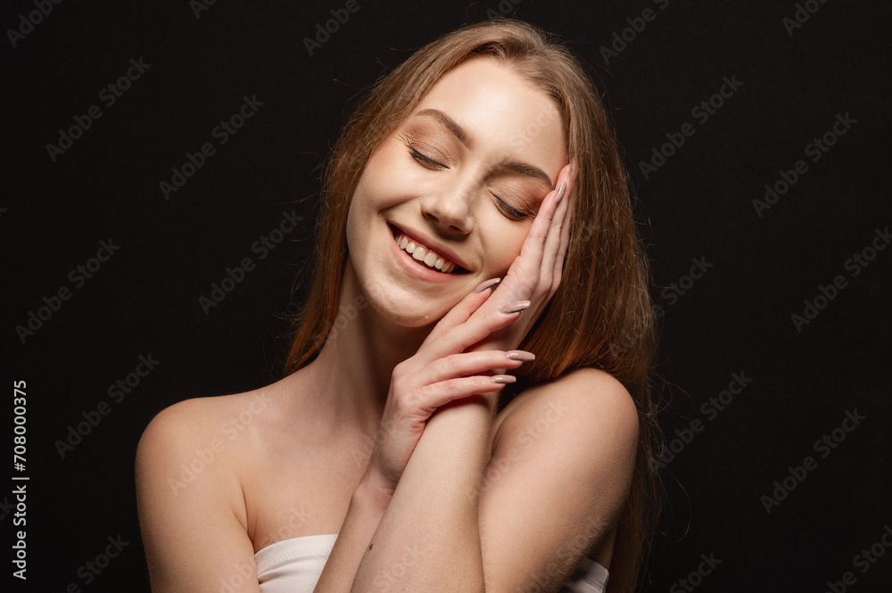 Beatiful portrait of a beautiful and gentle blonde girl on an isolated black background. Skin care Beatiful portrait of a beautiful and gentle blonde girl on an isolated black background. Skin care