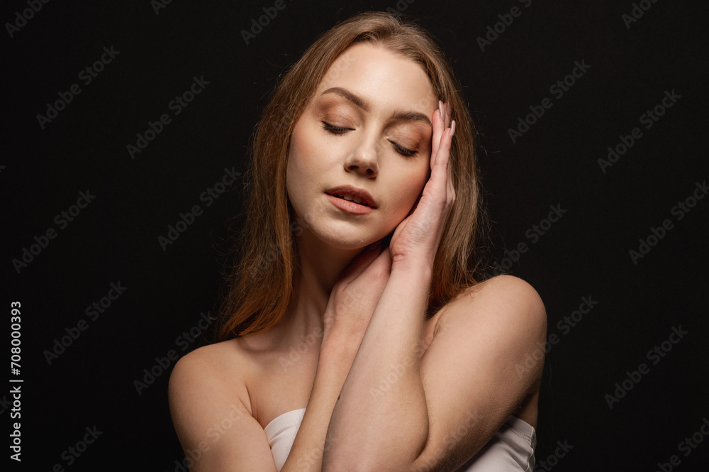 Beauty portrait of a pretty blonde woman posing on a black background. Skin care concept Beauty portrait of a pretty blonde woman posing on a black background. Skin care concept