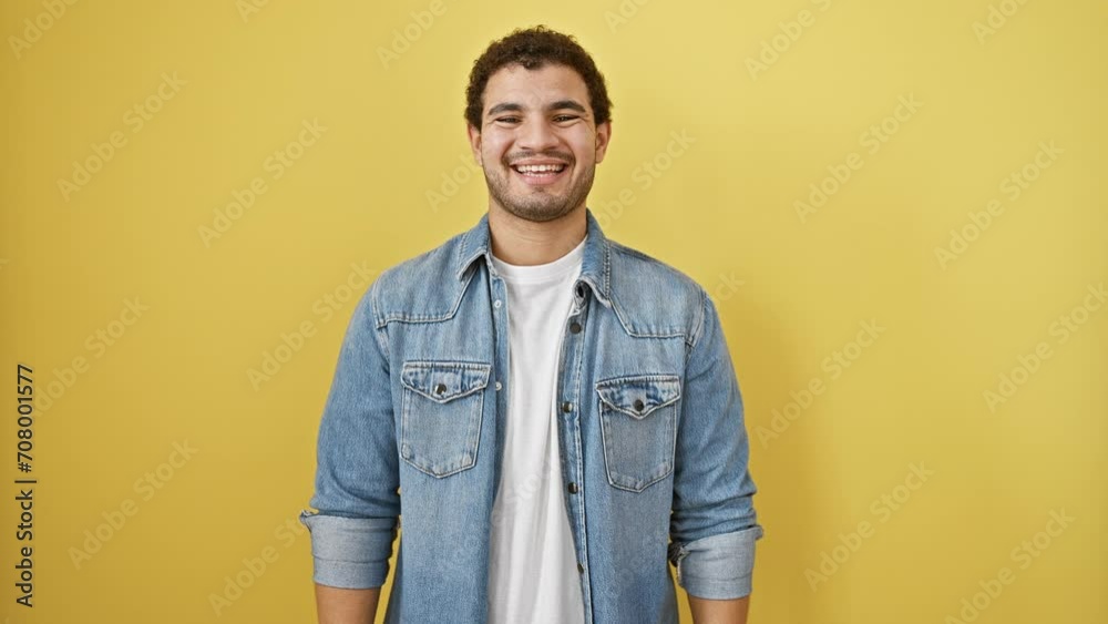 Cheerful young arab man exuding positivity, confidently standing with a beaming, toothy smile against an isolated yellow background, portraying joy and utter felicity. Cheerful young arab man exuding positivity, confidently standing with a beaming, toothy smile against an isolated yellow background, portraying joy and utter felicity.