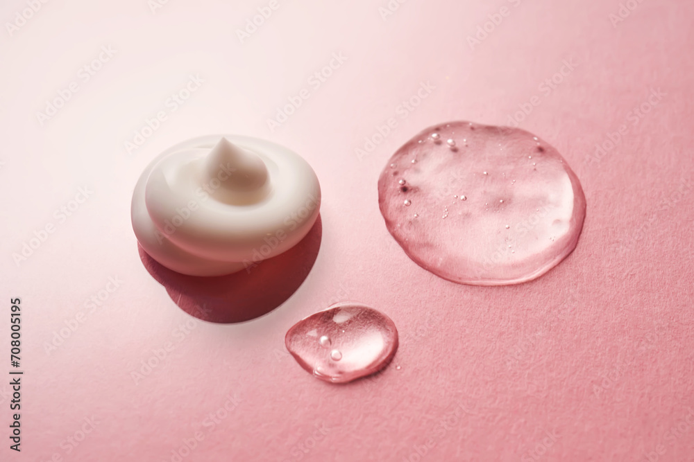 Gel, serum and a cream on a pink background.