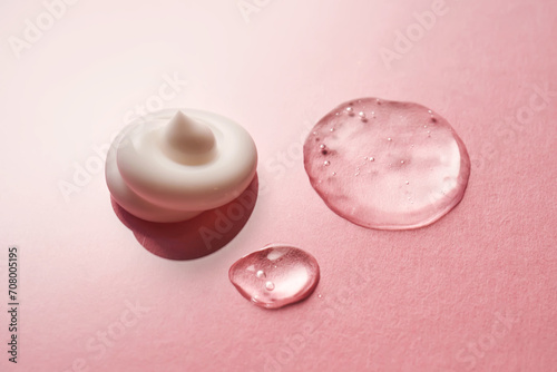 Gel  serum and a cream on a pink background.