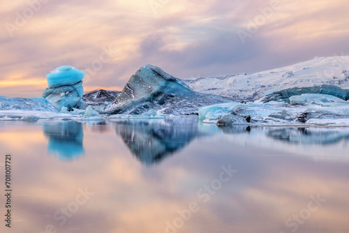 Symmetrical reflection of blue Icebergs in Jokulsarlon Glacier Lagoon in Iceland photo