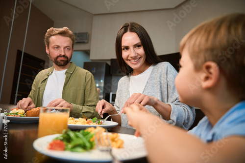 Cheerful family enjoying weekend breakfast together during Christmas celebration