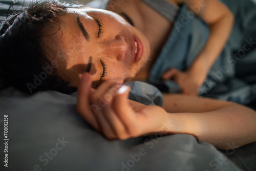Asian Woman Asleep in Comfortable Bed