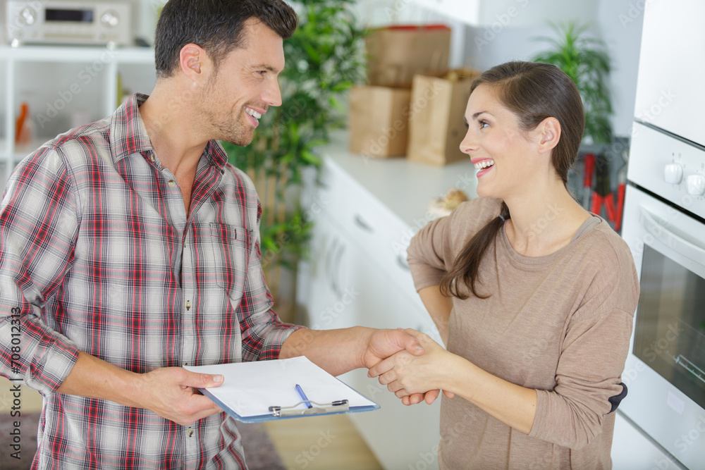 repairman shaking hands with woman repairman shaking hands with woman