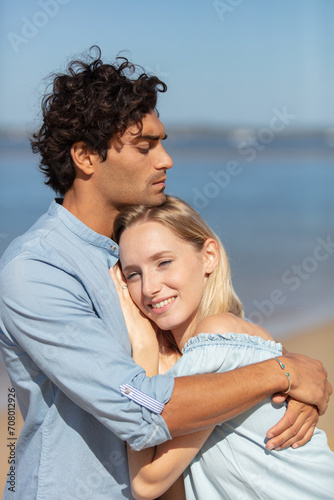 man seducing a woman whispering on her ear
