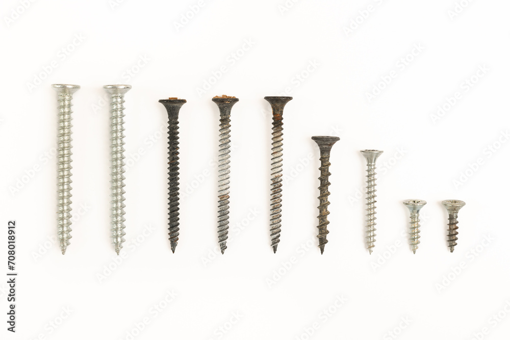 Self-tapping screws of different sizes isolated on a white background Self-tapping screws of different sizes isolated on a white background