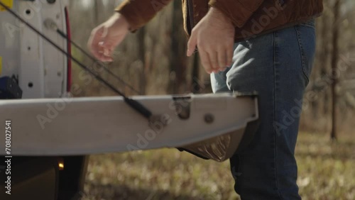 Man unloading bricks from a pickup truck and building an outdoor fire pit