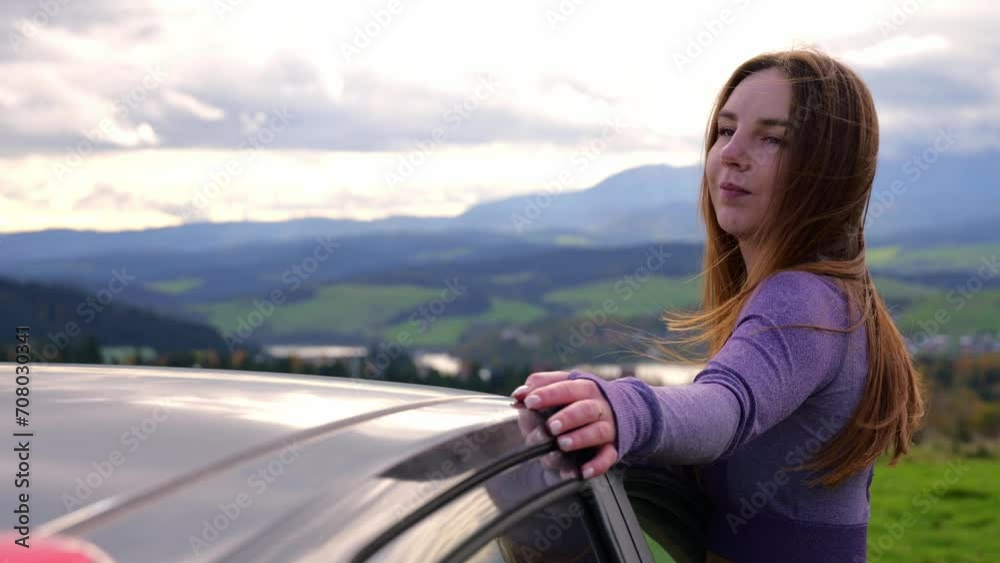 girl looks at the mountains from the car window girl looks at the mountains from the car window