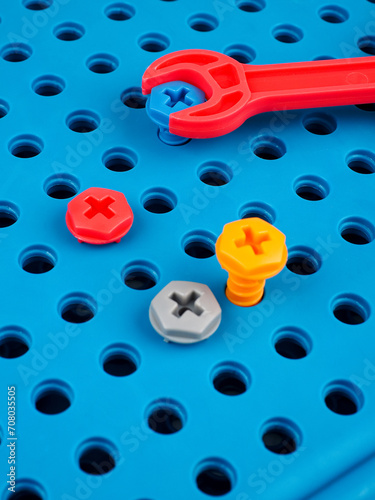 children's colorful plastic construction set, which includes an electric drill, screws, bolts and screwdrivers. various details and twisting. view from above.