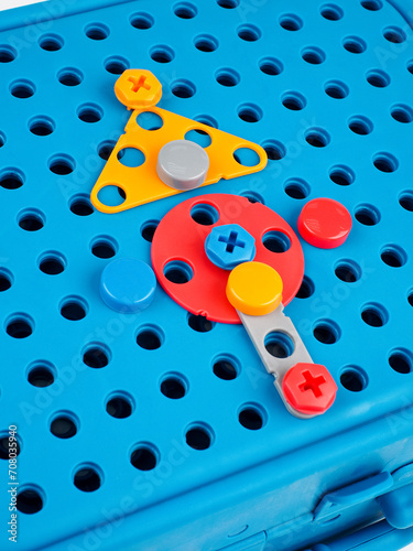 children's colorful plastic construction set, which includes an electric drill, screws, bolts and screwdrivers. various details and twisting. view from above.