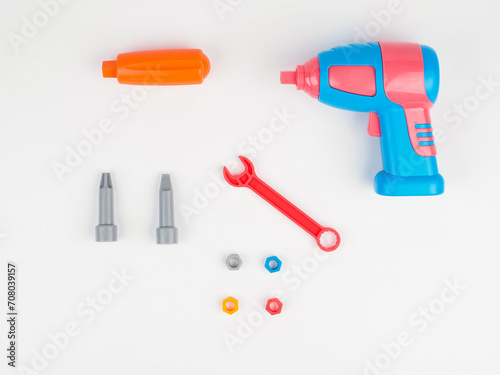 children's colorful plastic construction set, which includes an electric drill, screws, bolts and screwdrivers. view from above.