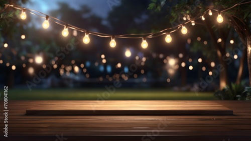 Empty Wood table top with decorative outdoor string lights hanging on tree in the garden at night time	