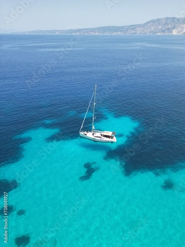 Drone view of the yacht sailing in the Ionian sea near Fteri beach, Kefalonia island, Greece © Kate Ra