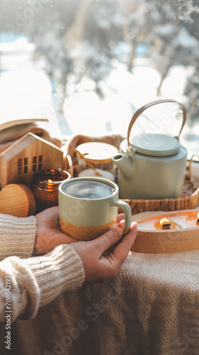 Girl holding a cup of tea in her hands, good morning concept photo