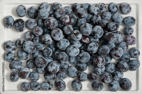 home plums on a white background. Top view. Useful fruits from the garden