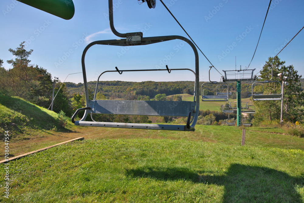 Chairlifts at ski resort in fall with no snow and lots of grass Chairlifts at ski resort in fall with no snow and lots of grass