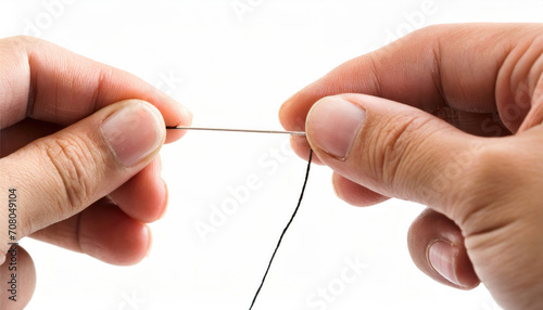 Hand holding a needle and thread