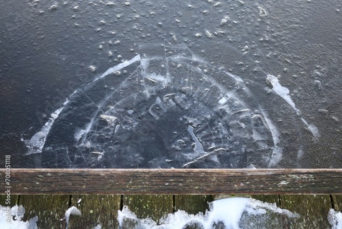 Canvas Print Hole in the ice for winter bathers in front of wooden pier
