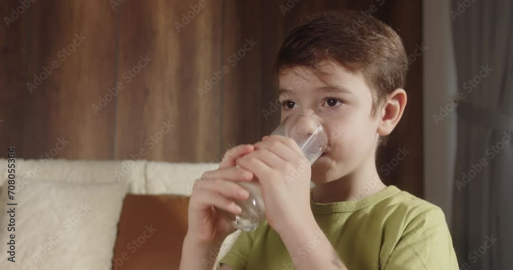 little boy in living room drinks yogurt milk and licks her lips. Happy smiling Child drinking milk. Healthy eating child eating breakfast kid dream concept. Positive kid smiling having breakfast. 4K little boy in living room drinks yogurt milk and licks her lips. Happy smiling Child drinking milk. Healthy eating child eating breakfast kid dream concept. Positive kid smiling having breakfast. 4K
