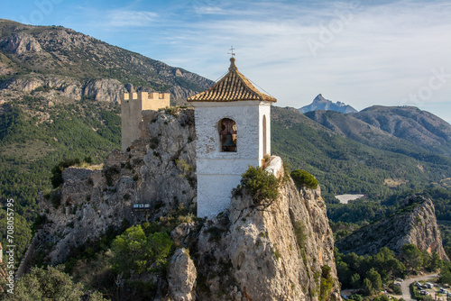 View of the medieval Guadalest castle with a part of the fortifications in the tourist town of Guadalest in a mountainous area of the Marina Baixa comarca, in Alicante, Spain