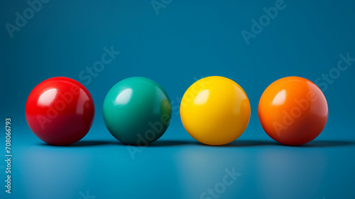 Red, orange, yellow and green balls on a blue background