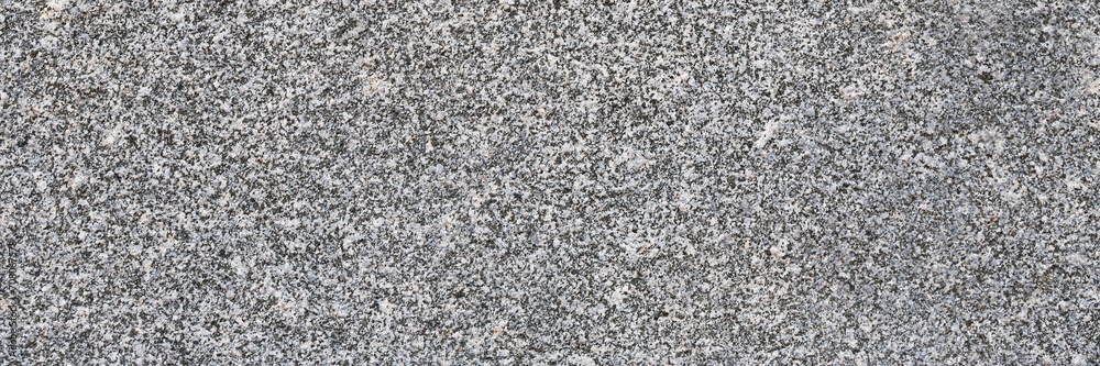 Granite texture. Natural gray granite with a grainy pattern. Stone background. Solid rough surface of rock. Durable construction and decoration material. Close-up. Granite texture. Natural gray granite with a grainy pattern. Stone background. Solid rough surface of rock. Durable construction and decoration material. Close-up.