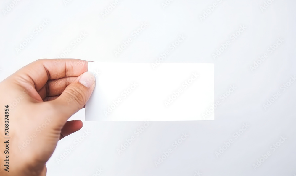 Hand holding a blank business card