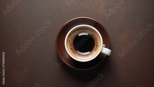 Hot espresso standing on brown background, top view, copy space