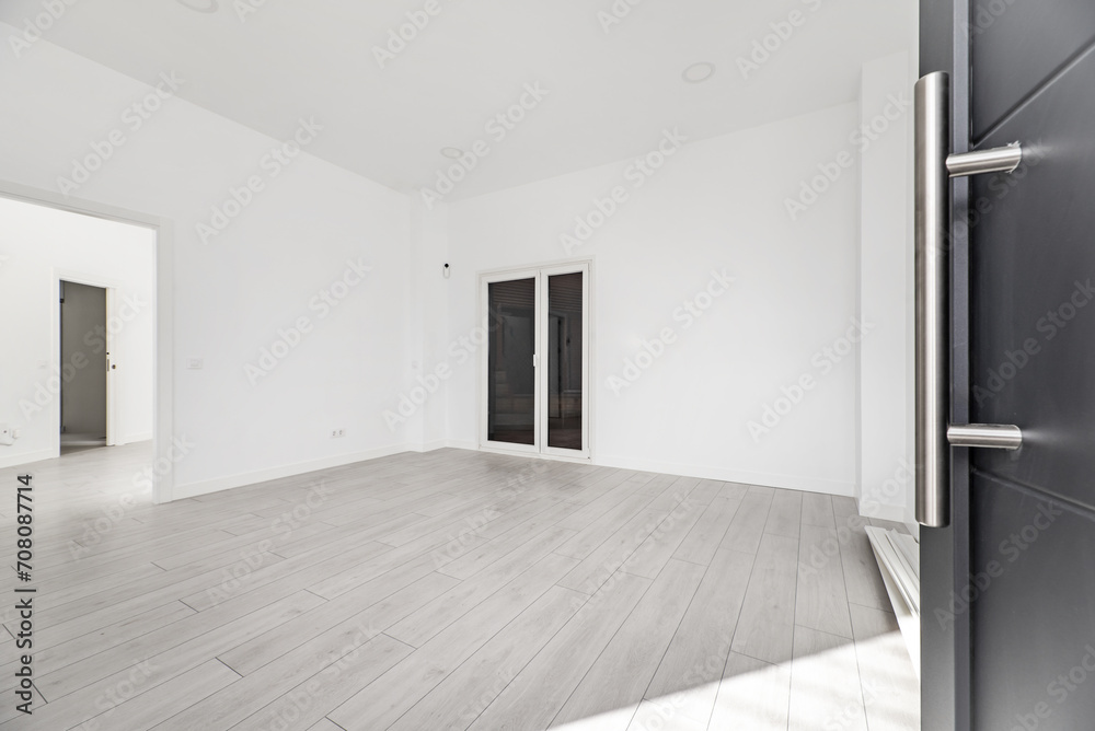 Obraz premium Hallway of a loft-type home with gray armored access door