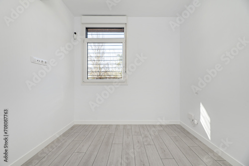 Empty room with light floors and aluminum windows
