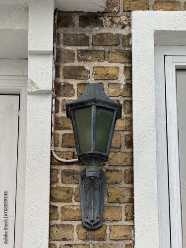 Street light hanging on building wall, outside of building