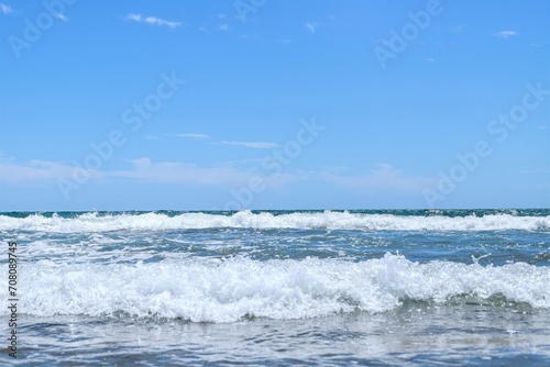 Fototapeta Naklejka Na Ścianę i Meble -  Blue sea  wiht wave and blue sky background. Summer sea and blue sky.