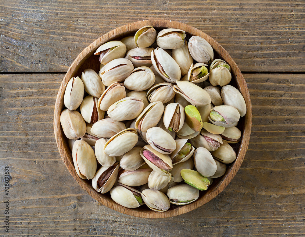 Pistachio Nut Background with Shell in a bowl, top viewed, view from above Pistachio Nut Background with Shell in a bowl, top viewed, view from above