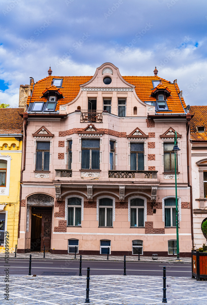 Building With Red Fire Hydrant in Front - Brasov, Romania, Transylvania Travel. A simple yet eye-catching image of a building with a vibrant red fire hydrant in the foreground.