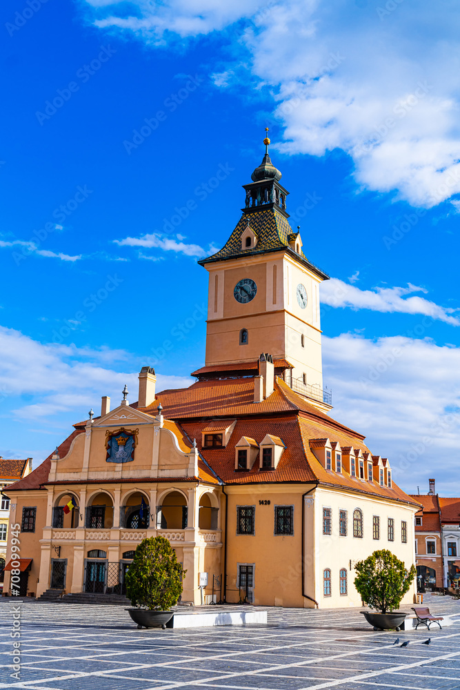 Iconic Clocktower on Grand Building in Brasov, Romania. A striking sight in Brasov, Romania, this large building features a prominent clocktower on its rooftop.