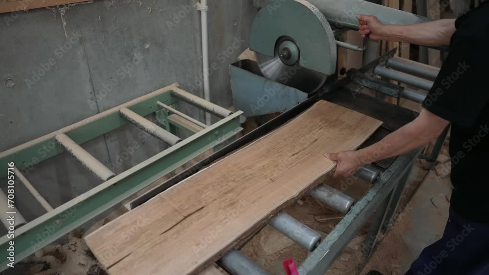 A wooden board is being sawed with circular saws, a crucial step in the preparation of blanks for wooden products. A wooden board is being sawed with circular saws, a crucial step in the preparation of blanks for wooden products.