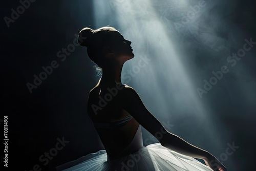 Graceful ballerina posing elegantly in a spotlight
