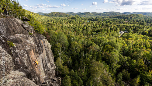 Climber on the wall in the forest