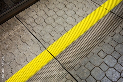 Yellow security mind the gap line on train station platform