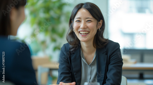 Japanese Businesswoman in Job Interview: Candid Meeting, Recruitment Talk, Manager and Candidate Discussion, Happy HR Management Interaction, Middle Aged Professional Negotiation, Business People Enga photo