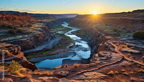 Majestic sandstone cliff, water flowing, sunset beauty generated by AI