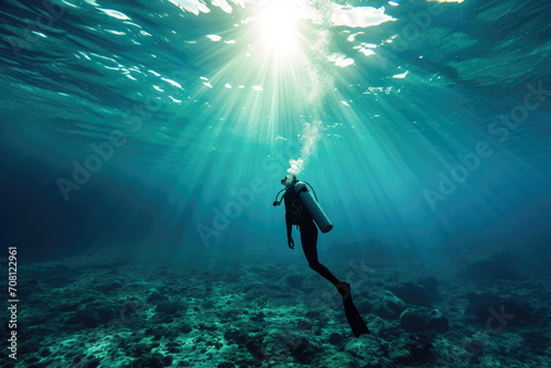 A scuba diver dives in the beautiful ocean.