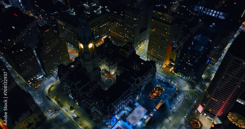 The clock is lit on the tower of gorgeous Philadelphia City Hall at night. Top view on the seat of the municipal government of in the U.S. state of Pennsylvania. The clock is lit on the tower of gorgeous Philadelphia City Hall at night. Top view on the seat of the municipal government of in the U.S. state of Pennsylvania.