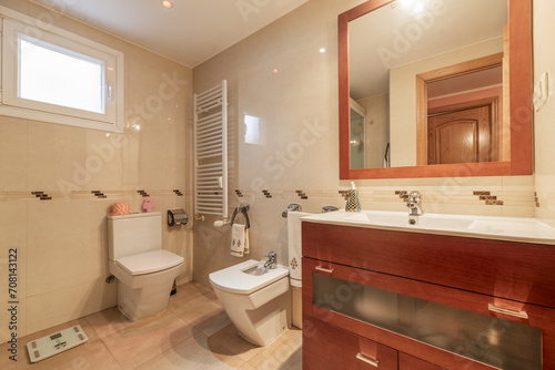 Bathroom with mahogany wood furniture with mirror