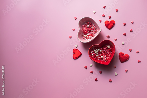Valentine's Day background. Containers for jimmies in the shape of a heart on a pink background photo