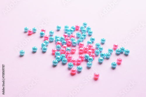 Blue and pink beads on a pink background. Bead making kit and beadwork elements