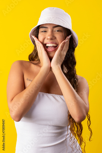 young woman wearing white dress on a yellow background