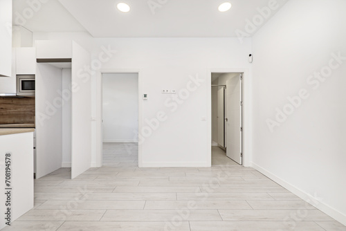 Front image of a loft-type home with open spaces with light wooden floors  access to the rest of the empty rooms