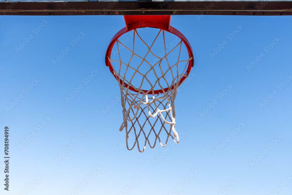 A metal basketball basket of the typical orange
